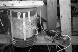 View of the CT transmitter and its loading coil, atop its protective garbage can located at the base of the antenna mast